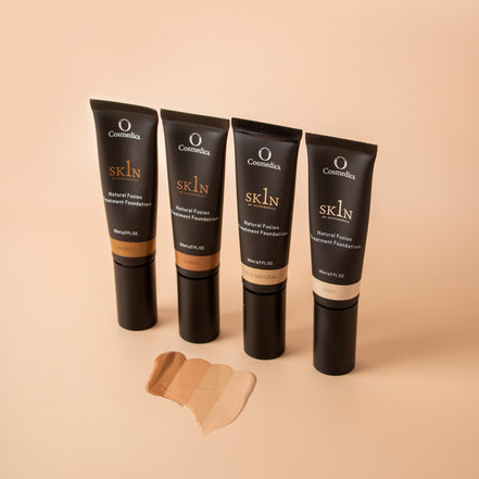 Four Cosmedix O Cosmedic 1Skin Treatment Foundation tubes on a beige background