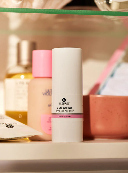 Anti Ageing Rose Hip Oil Plus on a shelf with other items in the background