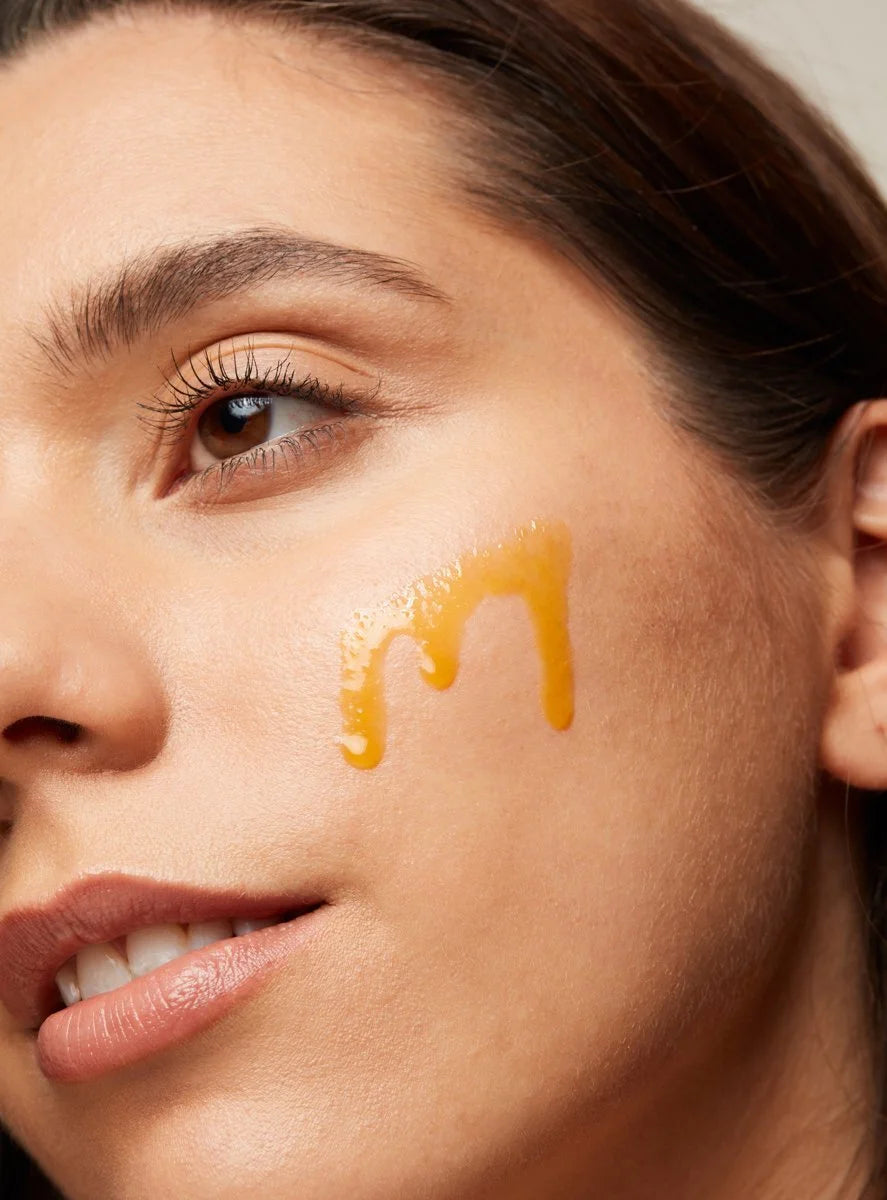 Close-up of a woman's face with Anti Ageing Rose Hip Oil Plus on her cheek