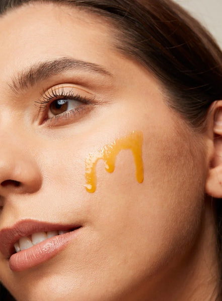 Close-up of a woman's face with Anti Ageing Rose Hip Oil Plus on her cheek