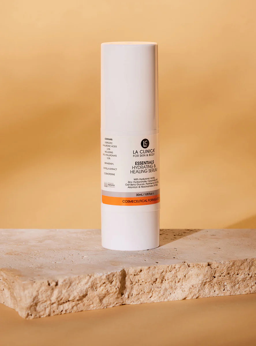 Essentials Hydrating & Healing Serum on a stone surface with a beige background