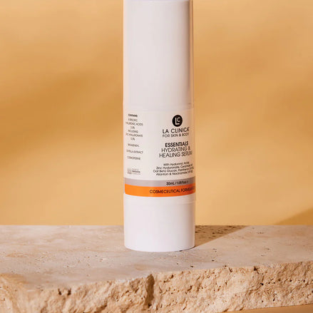 Essentials Hydrating & Healing Serum on a stone surface with a beige background