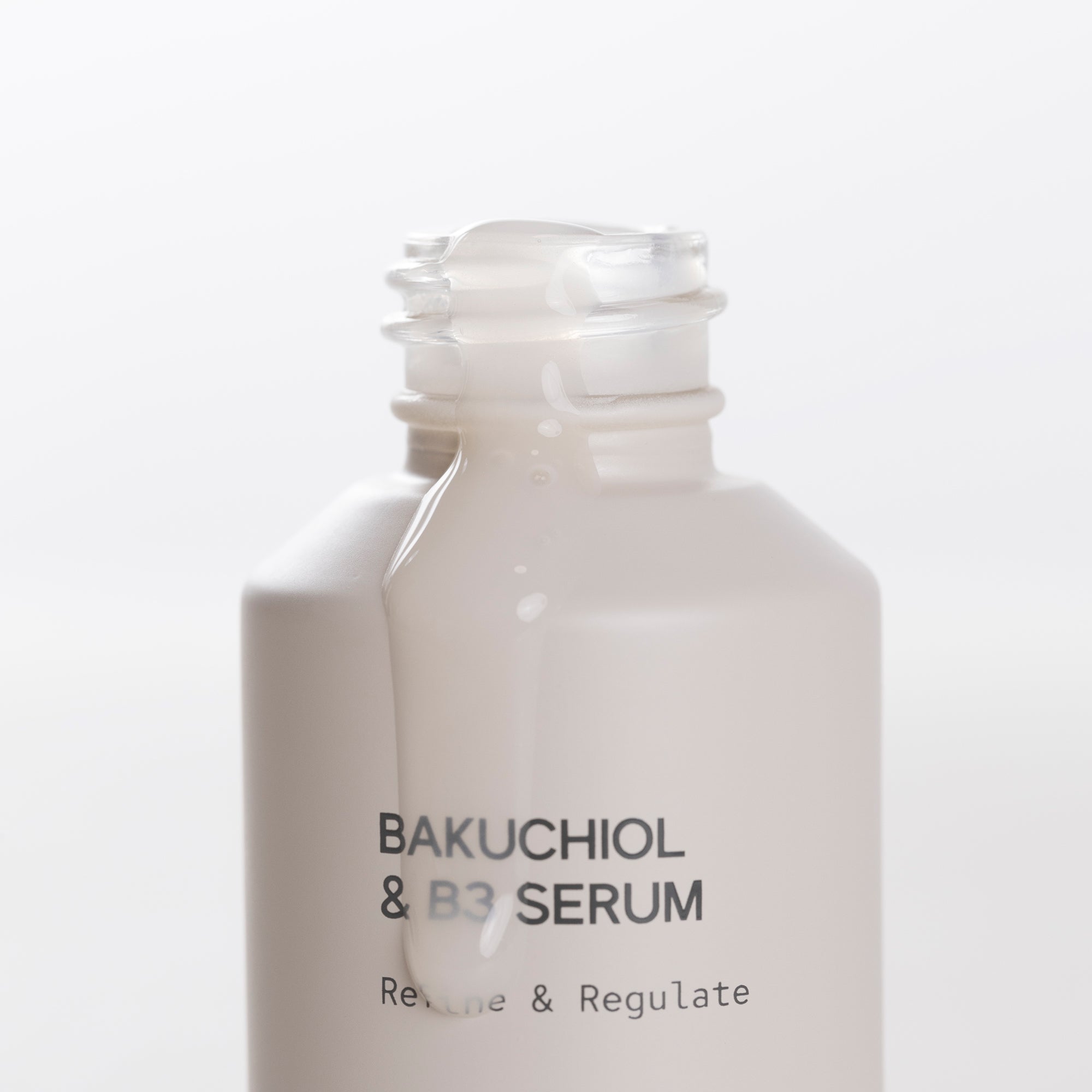 Bakuchiol & B3 serum open bottle on a white background
