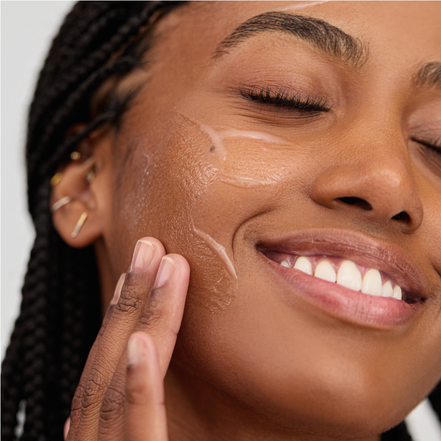 Woman applying Bakuchiol B3 Serum to her face with a close-up view.