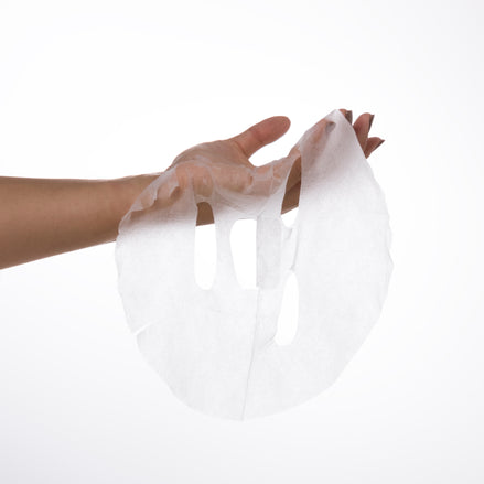 Person holding Calm & Soothe Daily Sheet Mask against a white background