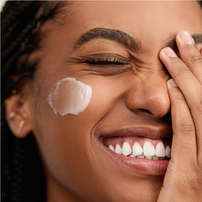 Woman applying Gel Cream Hydrator
to her face with a close-up focus on her skin texture.