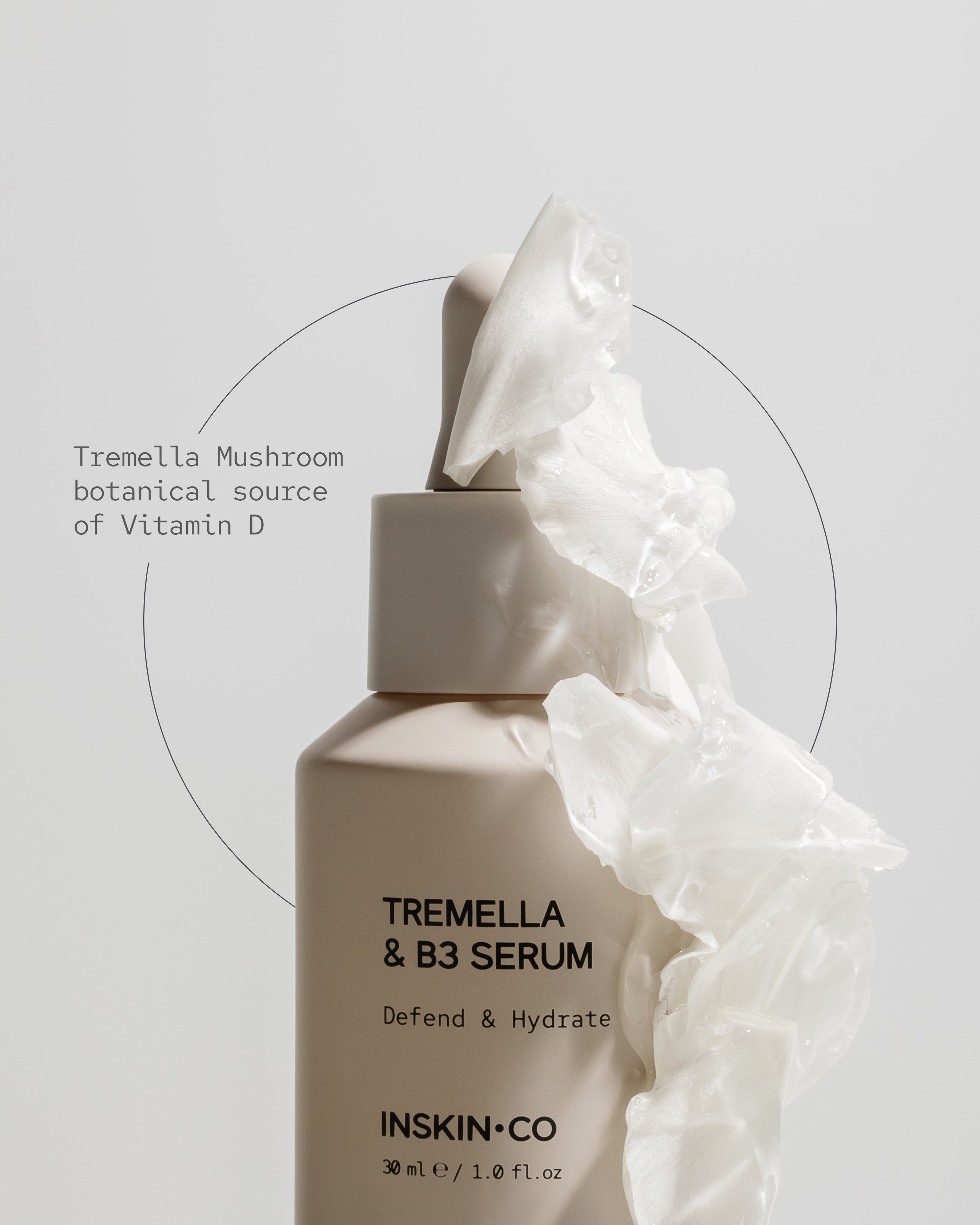 Tremella & B3 Serum bottle with white fabric on a light gray background