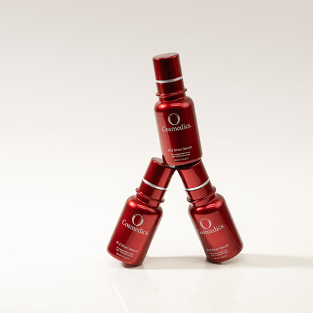 Three B12 Smart Serum bottles stacked on a white background with 'O Cosmetics' branding.