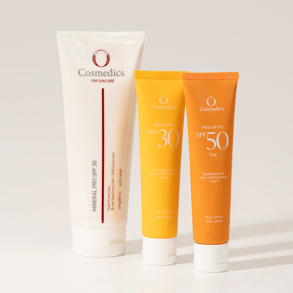 Three tubes of O Cosmedics sun care products on a light background