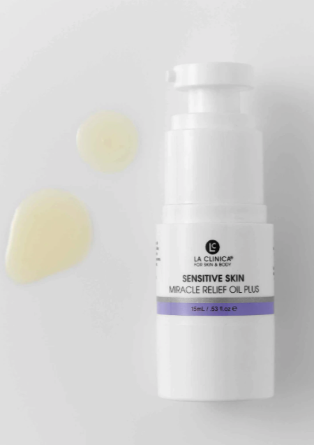 Skincare bottle labeled 'Sensitive Skin Miracle Relief Oil Plus' on a light gray background
